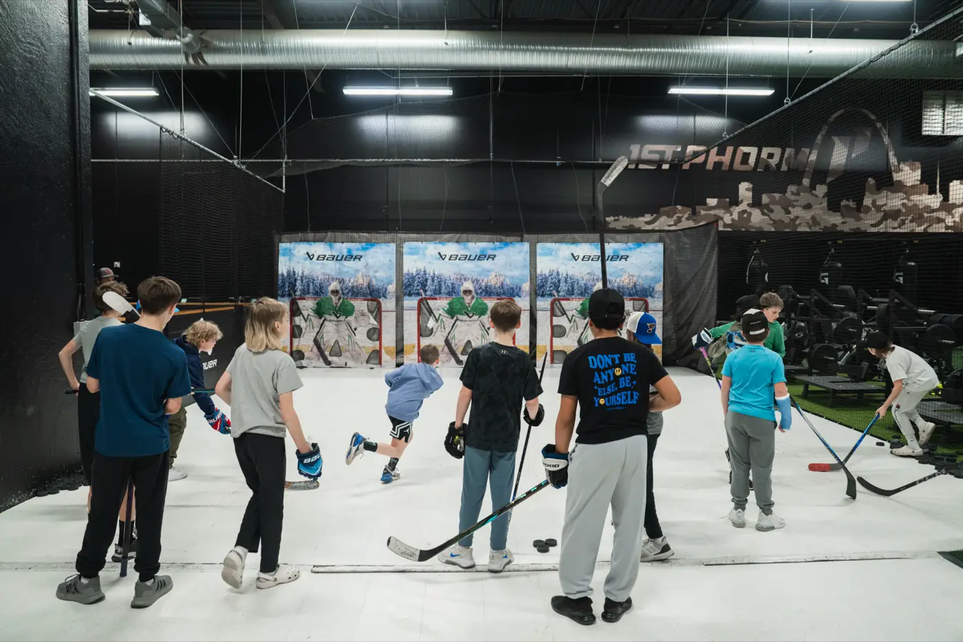 Kids with sticks working on their shot in the GMT shooting lanes
