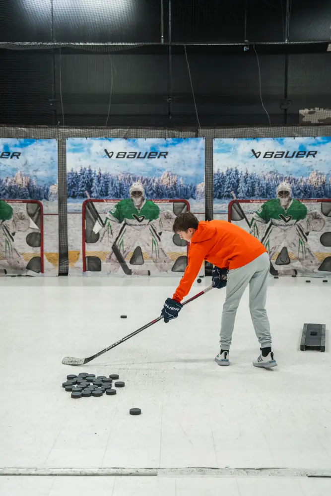 Player shooting pucks at goalie targets in the GMT shooting lanes